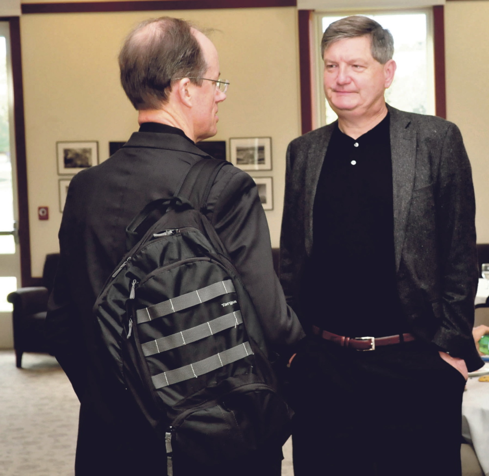 New York Times investigative reporter James Risen, right, speaks with former senior executive of the National Security Agency and whistleblower Thomas Drake at a journalism conference at Colby College in Waterville on Sunday. Risen received the annual Elijah Parish Lovejoy Award for courageous journalism.