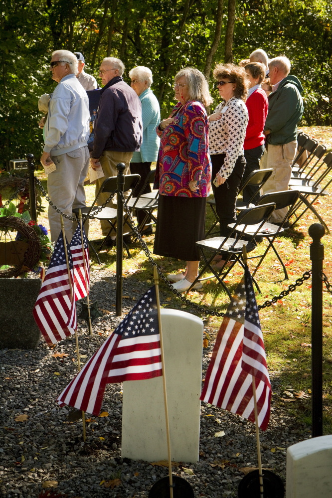 About 60 people gathered to rededicate Grand Trunk Cemetery Sunday. Many of the settlers buried in the reclaimed cemetery have been identified, and the research is to continue. Carl D. Walsh/Staff Photographer