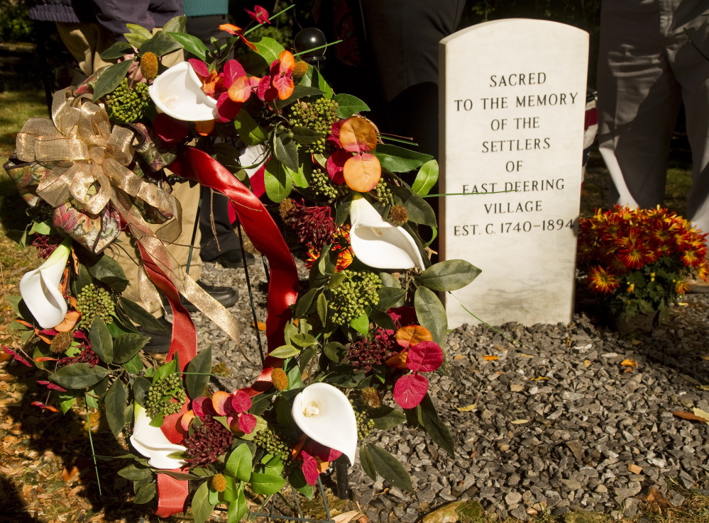 A wreath sits next to a memorial stone for the early settlers of East Deering. Carl D. Walsh/Staff Photographer