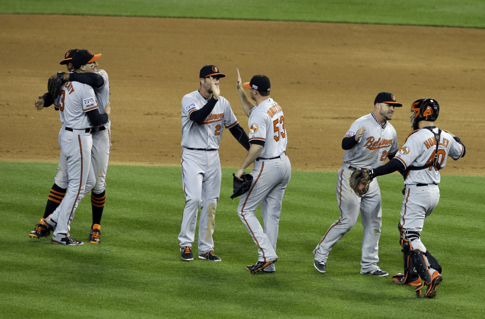 Baltimore Orioles players celebrate after defeating the Detroit Tigers, 2-1 in Game 3 of baseball’s AL Division Series Sunday, in Detroit. Baltimore won the series 3-0.