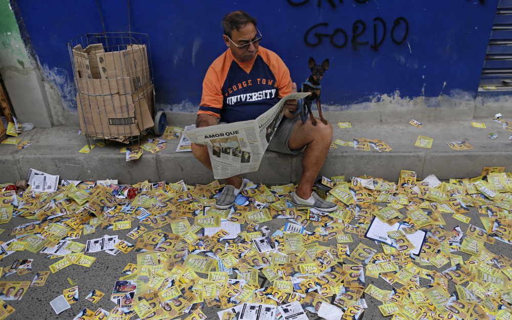 Campaign propaganda litters a sidewalk during general elections in a Rio de Janeiro, Brazil, slum on Sunday.
