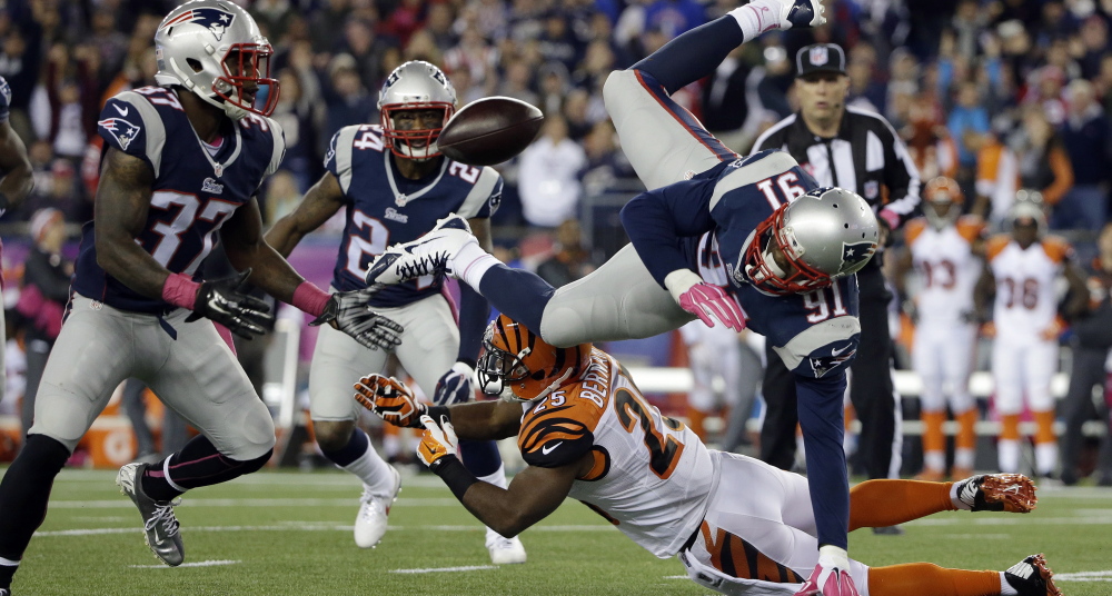 Bengals running back Giovani Bernard, bottom, upends Patriots linebacker Jamie Collins, right, who fumbles. New England cornerback  Alfonzo Dennard, left, ended up with the ball.