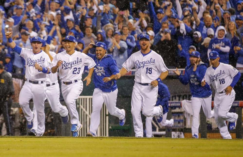 Kansas City Royals players erupt from the dugout following Game 3 of the American League Division Series in Kansas City, Mo., on Sunday. The Royals defeated the Los Angeles Angels 8-3 to sweep the series.