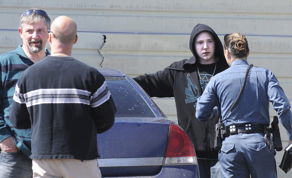 Frederick Horne Sr., left, and Frederick Horne Jr. speak with Maine State Police officers April 10 after being charged with sex trafficking at their Sidney residence.