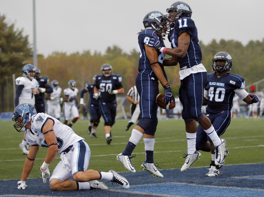 ORONO ME - OCTOBER 4: Arthur Williams, (89) celebrates with teammate Jordan Dunn (11) after Williams caught a 25-yard touchdown pass in the first quarter of a CAA college football game between Maine and Villanova at Alfond Stadium in Orono, Saturday, October 4, 2014. (Photo by Gabe Souza/Staff Photographer)