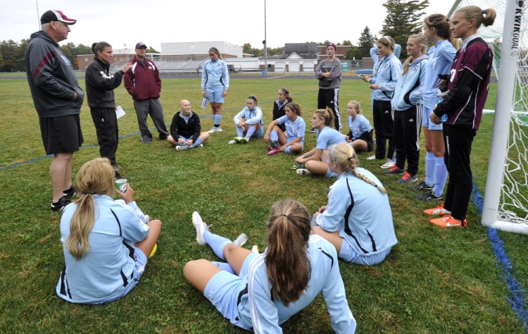 Windham Coach Deb Lebel, second from left, talks to her team at halftime of a recent game. The Eagles won the Class A state title last fall and, with a roster stacked with talented players who play the game year-round, are the favorites to win it again this fall. They are off to a 9-0 start.
