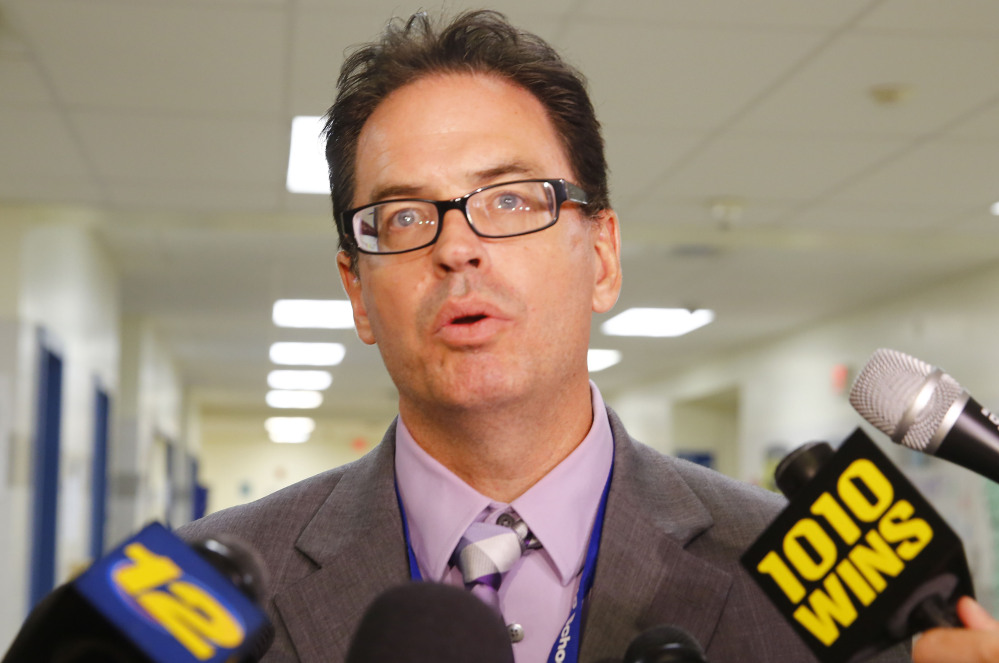 Superintendent Richard Labbe speaks to the media Monday about the cancellation of the football season at Sayreville War Memorial High School in Sayreville, N.J., because of allegations of harassment, intimidation and bullying by players.