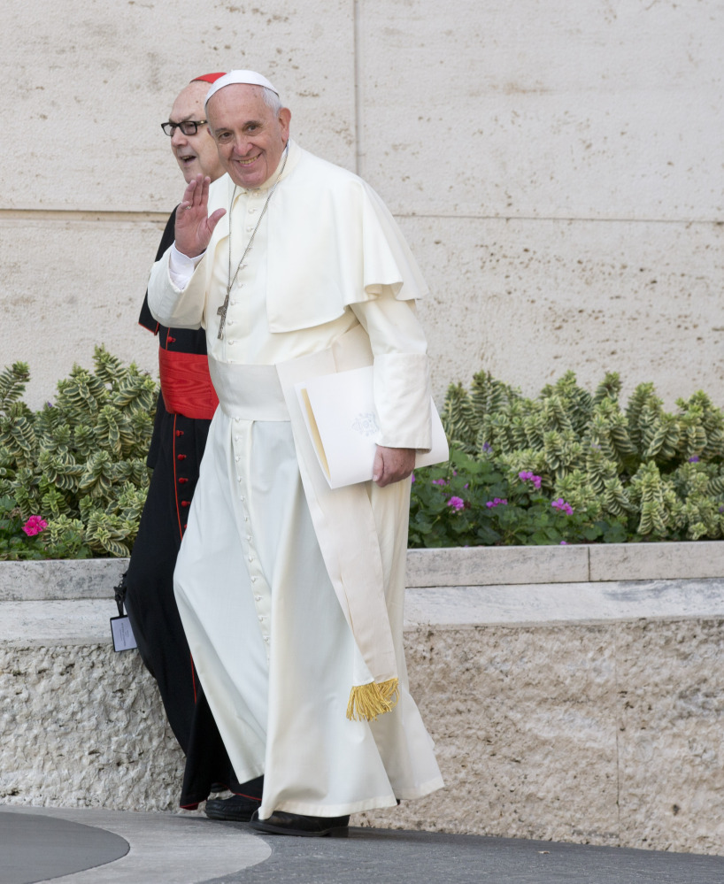 Pope Francis, with Cardinal Fernando Sebastian Aguilar, arrives at a morning session of a two-week synod on family issues at the Vatican on Tuesday.