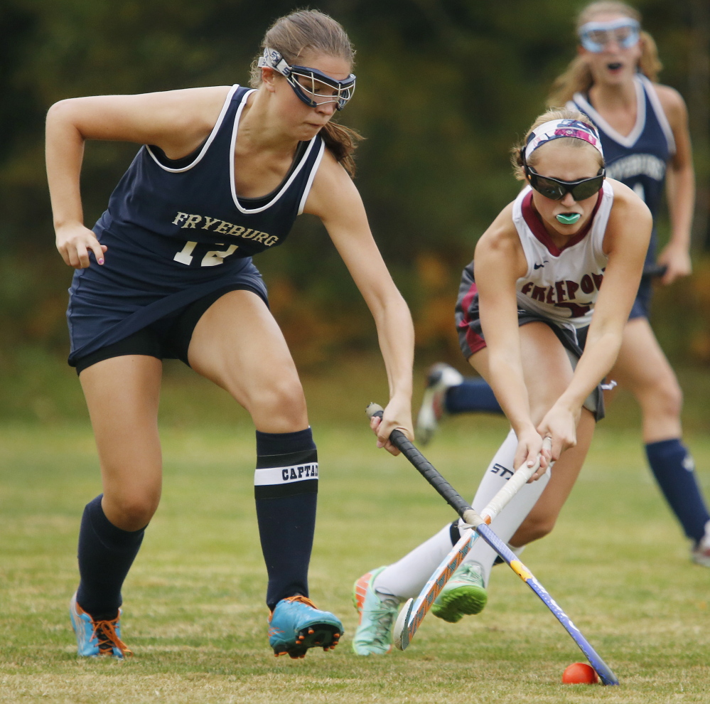 Mackenzie Hill of Fryeburg Academy, left, pulls the ball away from Hannah Williams of Freeport during their scoreless tie Tuesday in a Western Maine Conference field hockey game at Freeport.