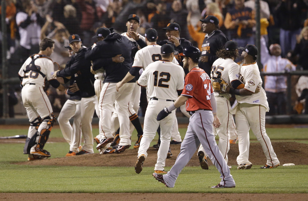 The San Francisco Giants celebrate after beating the Washington Nationals on Tuesday night in Game 4 of the NL Division Series in San Francisco. The Giants won the best-of-five series in four games.