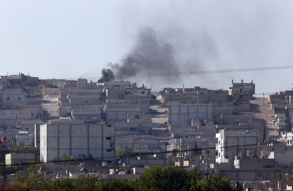 Smoke rises after a strike in Kobani, Syria as fighting intensifies between Syrian Kurds and the militants of Islamic State group, as seen from Mursitpinar on the outskirts of Suruc, at the Turkey-Syria border,  Wednesday.