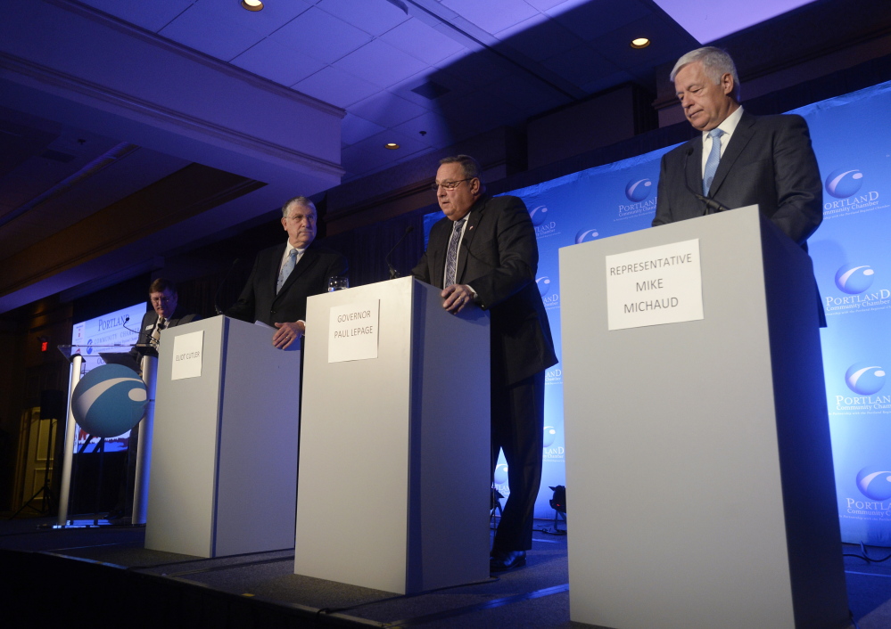 From left, Eliot Cutler, Paul LePage and Mike Michaud participate Wednesday in the first gubernatorial debate of the campaign at the Holiday Inn by the Bay in Portland.