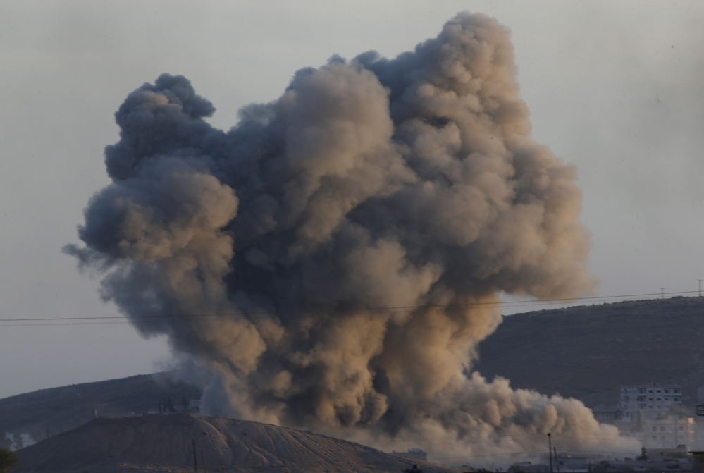 A huge plume of smoke rises after an airstrike in eastern Kobani on Wednesday.