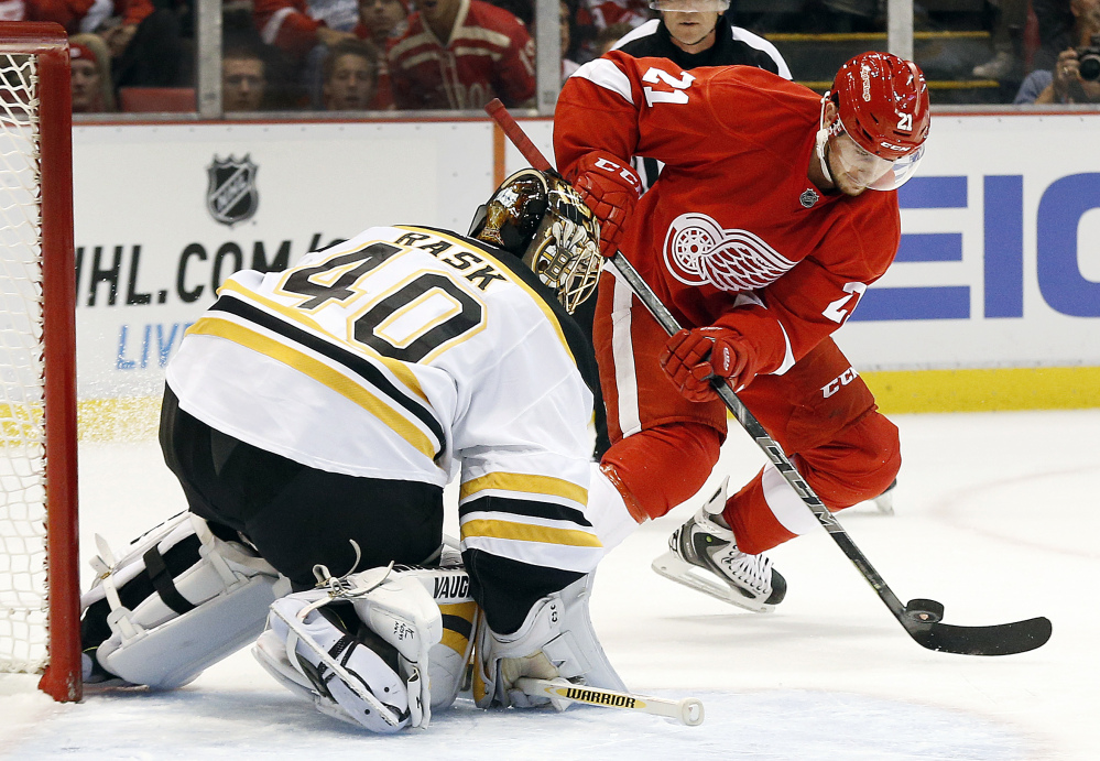 Boston Bruins goalie Tuukka Rask stops a shot by Detroit Red Wings left wing Tomas Tatar in the second period Thursday night in Detroit. The Red Wings scored twice in the period and beat the Bruins, 2-1.