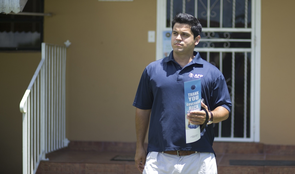 Andres Malave, a volunteer with the conservative Americans for Prosperity, canvasses a west Miami neighborhood in August, talking with voters to hone the group’s message.