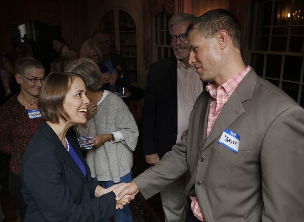 Shenna Bellows, the Democratic candidate for U.S. Senate, greets Bryce Hach of Falmouth at a fundraiser in Falmouth. “House parties” are a mainstay of the Bellows campaign as the race enters the final month.
