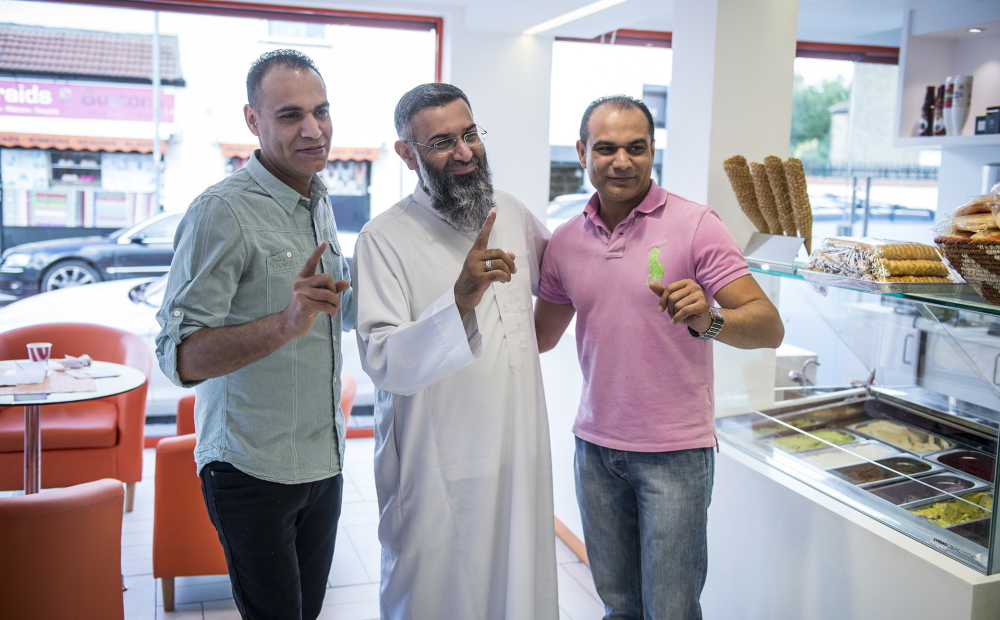 Anjem Choudary, center, has his share of admirers, including these men posing for a photo with him recently in Ilford, northeast London. Choudary, a lawyer by training, has been involved in extremist activities for nearly 20 years.
