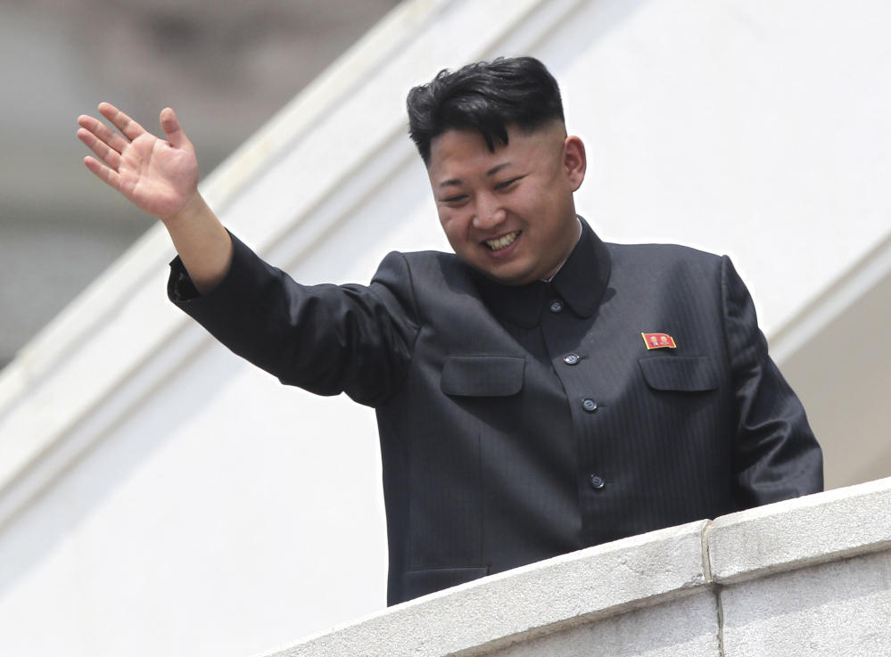 In this July 27, 2013 photo, North Korean leader Kim Jong Un waves to war veterans during a mass military parade celebrating the 60th anniversary of the Korean War armistice in Pyongyang.