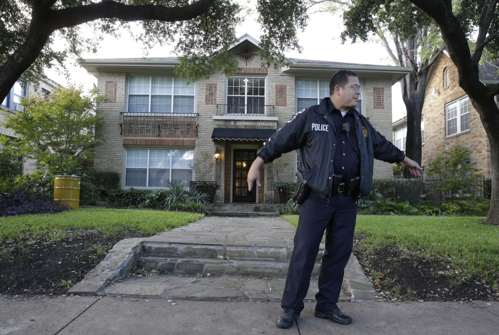 Police stand guard outside the apartment of nurse Nina Pham, and a yellow barrel, left, that holds hazardous materials Sunday in Dallas. Pham, who was in full protective gear when she provided hospital care for Ebola patient Thomas Eric Duncan, who later died, has tested positive for the virus.