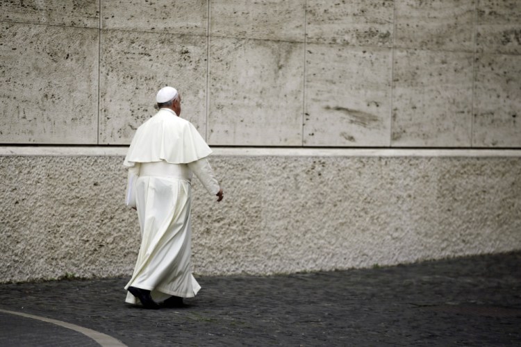 Pope Francis leaves at the end of a morning session of a two-week synod on family issues at the Vatican on Monday.