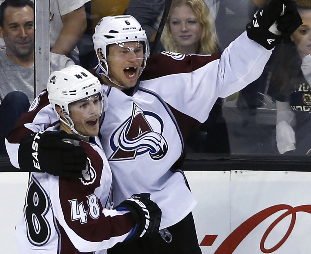 Colorado’s Daniel Briere, left, celebrates with teammate Erik Johnson after his goal with less than a second left in the third period gave the Avalanche a 2-1 win Monday at Boston.