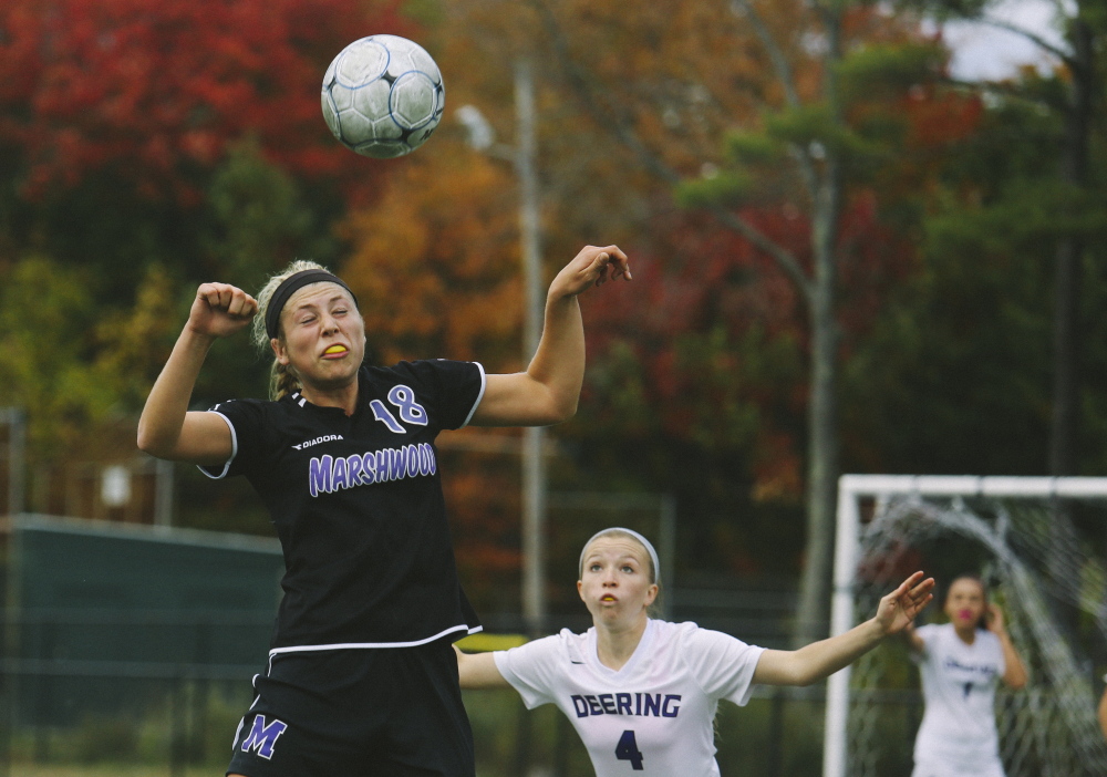 Marshwood’s Korinne Bohunsky goes up for a header as Deering’s Luci Santerre defends during Marshwood’s 2-1 win Monday at Deering’s Memorial Field. Bohunsky had a first-half goal for the Hawks, ranked No. 3 in Western Class A.