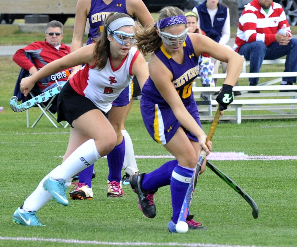 Lydia Henderson of South Portland, left, competes for the field hockey ball with Abby Ford of Cheverus during South Portland’s 2-1 victory Tuesday at home.