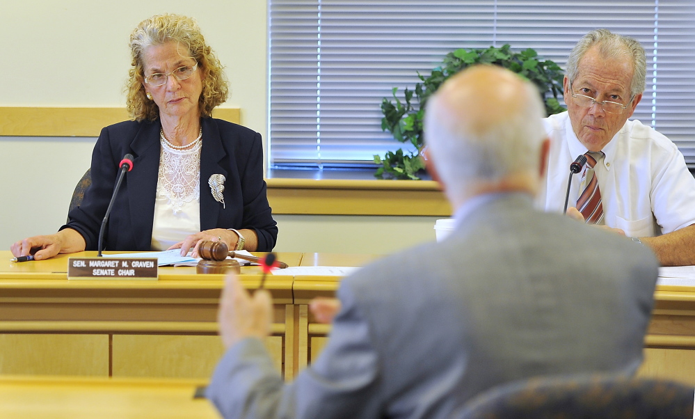 Maine Sen. Margaret Craven, Senate chair of the Health and Human Services Committee, and Rep. Richard Farnsworth, House chair, listen as Jay Harper, interim superintendent at Riverview, responds to questions from committee members at a hearing in Augusta on Wednesday.
