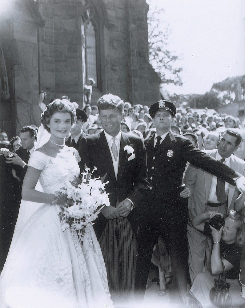 In this Sept. 12, 1953, photo released by RR Auction, U.S. Sen. John F. Kennedy and his new bride, Jacqueline, exit St. Mary’s Church after their wedding in Newport, R.I.