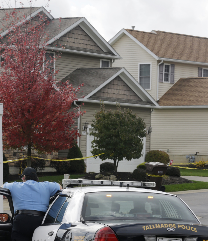 A Tallmadge auxiliary police officer keeps watch on a home Thursday in Tallmadge, Ohio, where  nurse Amber Joy Vinson stayed over the weekend before flying home to Dallas. She later tested positive for Ebola.
