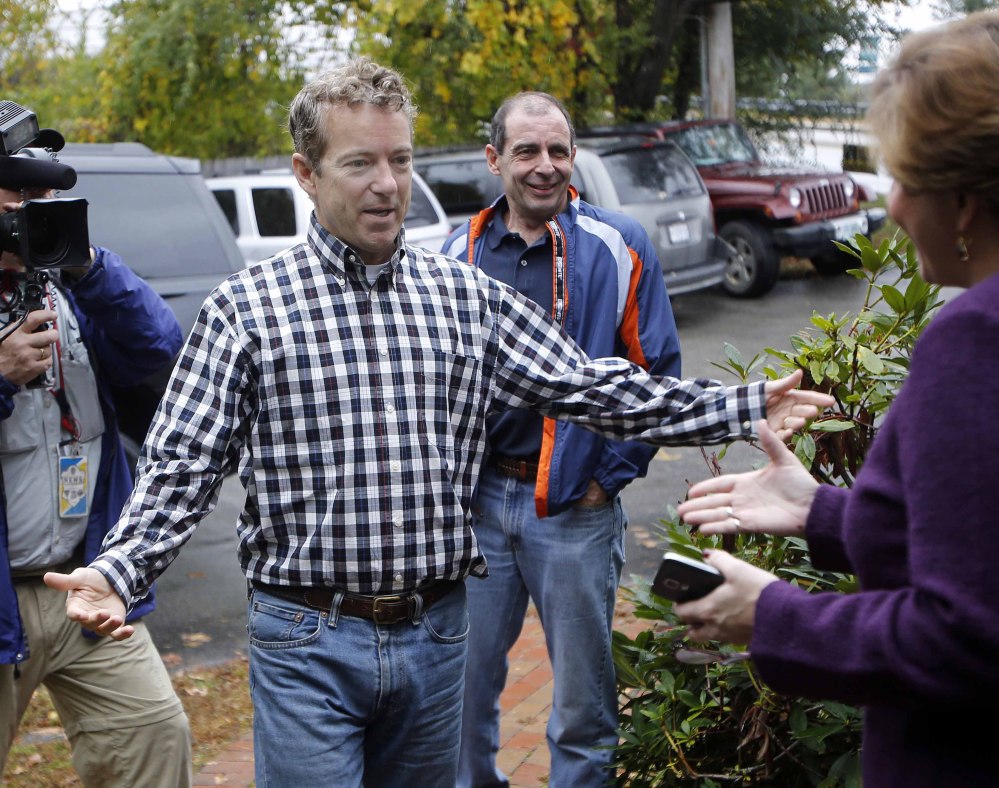 Sen. Rand Paul, R-Ky., is greeted Thursday by state Republican Chair Jennifer Horn at the party’s headquarters in Concord, N.H. In his third visit to the state this year, Paul rallied voters ahead of the November election.