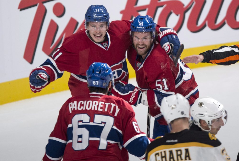 Montreal’s Brendan Gallagher, left, and David Desharnais celebrate a power-play goal by teammate Max Pacioretty against the Boston Bruins in first period of Thursday night’s game in Montreal.