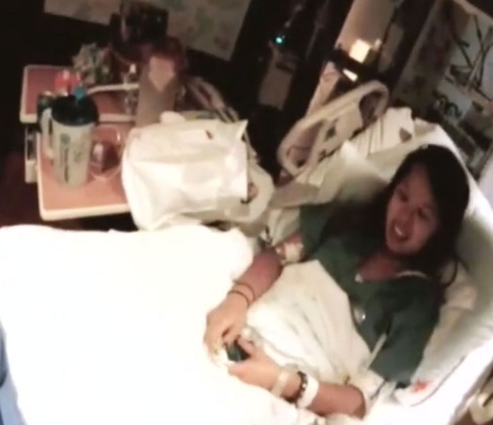 In this frame grab from video provided by Texas Health Resources, Nina Pham, who contracted Ebola after treating a Liberian man, talks while being recorded at Texas Health Presbyterian Hospital in Dallas, Thursday, Oct. 16, 2014, before being flown to the National Institutes of Health outside Washington. Pham is shown in the video — posted online by the hospital’s parent company — smiling as she sits upright in a hospital bed while a man identified as her treating physician can be heard thanking her for getting well and being part of the volunteer team that took care of the first patient. (AP Photo/Texas Health Resources, Dr. Gary Weinstein)