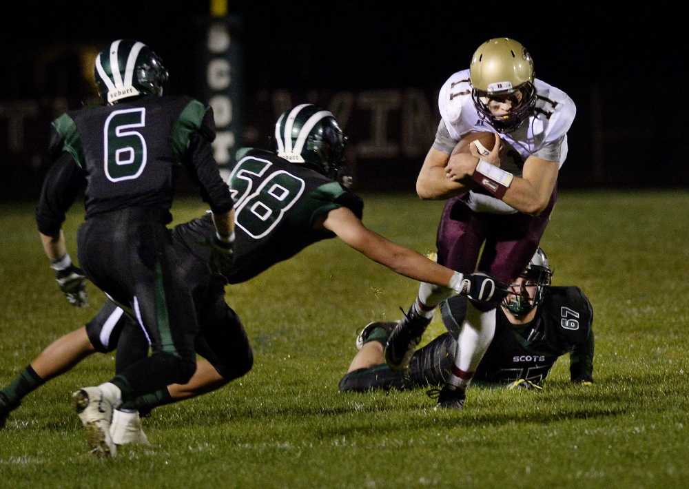Thornton Academy’s quarterback Austin McCrum picks up yardage as he maneuvers between Bonny Eagle defenders Dylan Ricci, left, Mason White, center, and Lukkas Pierce. Thornton improved to 6-1 with a 28-12 win.