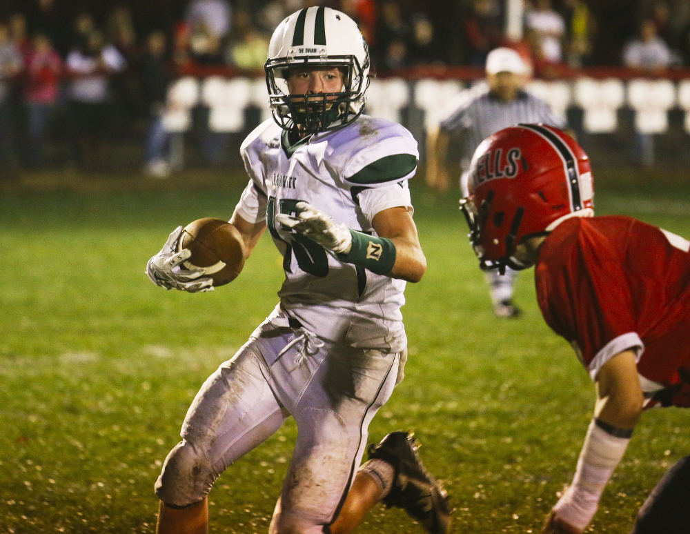 Billy Bedard, who batted down the pass that ended Wells’ last chance Friday night and preserved a 26-19 victory for Leavitt, looks for a way around Riley Dempsey of Wells.