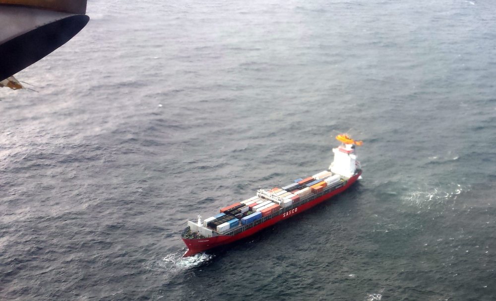 A Canadian Coast Guard helicopter flies near a Russian container ship, carrying hundreds of tons of fuel drifts without power in rough seas off British Columbia’s northern coast on Friday.
