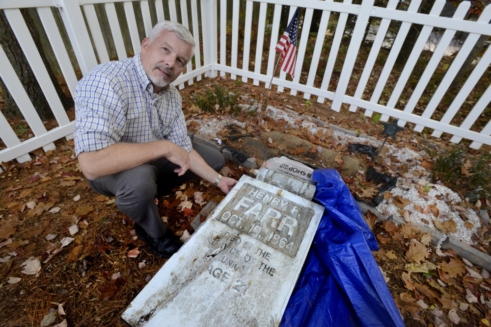 SCARBOROUGH, ME - OCTOBER 15: Mike Waters at his great-great-great grandfathers, Henry Farr, grave in Scarborough where he will replace a old wooden head stone with a new granite one. (Photo by John Patriquin/Staff Photographer)