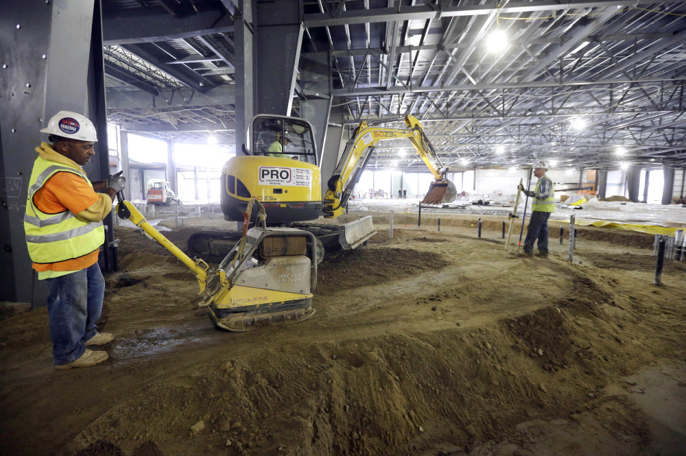 A crew works at the site of Penn National Gaming’s slots parlor under construction in Plainville, Mass.