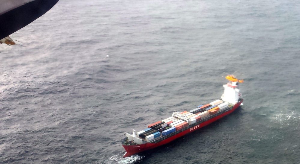 A Canadian Coast Guard helicopter flies near a Russian container ship carrying hundreds of tons of fuel, which was drifting without power in rough seas off British Columbia.