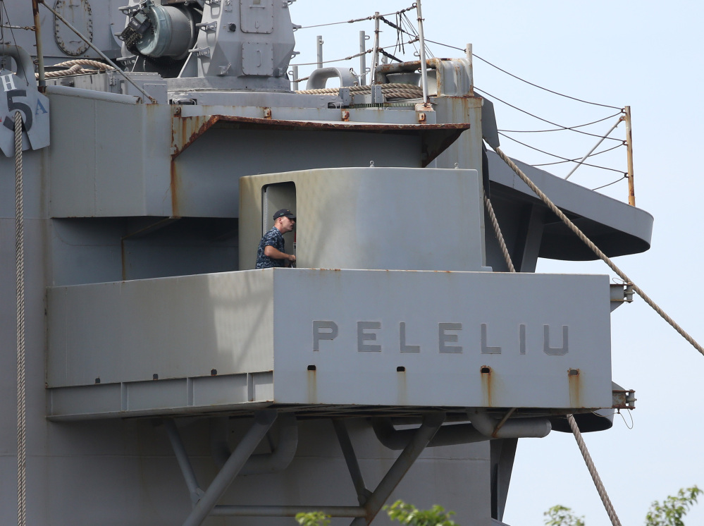 A U.S. marine walks inside the USS Peleliu, where U.S. Marine Pfc. Joseph Scott Pemberton is said to be detained after allegedly killing Filipino transgender Jennifer Laude at the Subic Bay free port, Zambales province, northern Philippines.