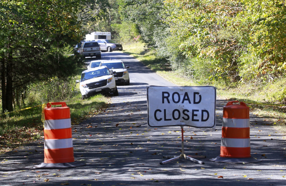 A road closed sign blocks traffic as authorities search a rural area where human remains were discovered in Albermarle County, Va., Sunday.