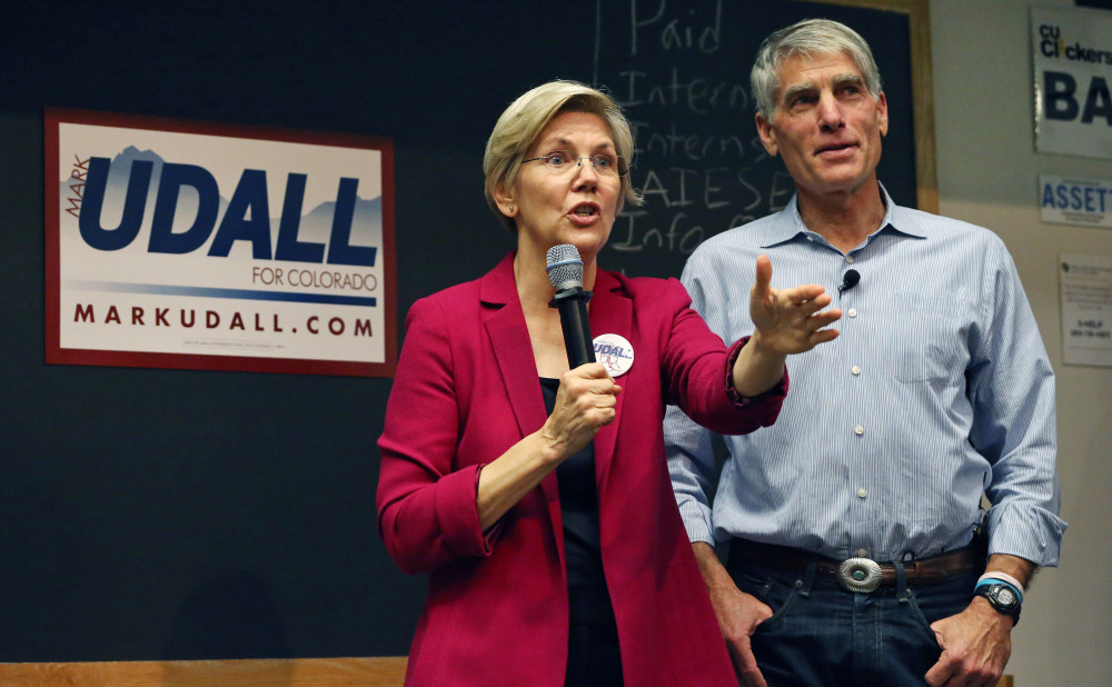 Sen. Elizabeth Warren, D-Mass., left, urges the re-election of Colorado Sen. Mark Udall at a rally Friday at the University of Colorado in Boulder.