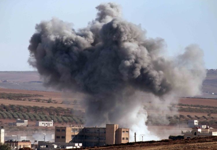 U.S.-led coalition warplanes make an airstrike in Kobani, Syria, in this 2014 photo. 