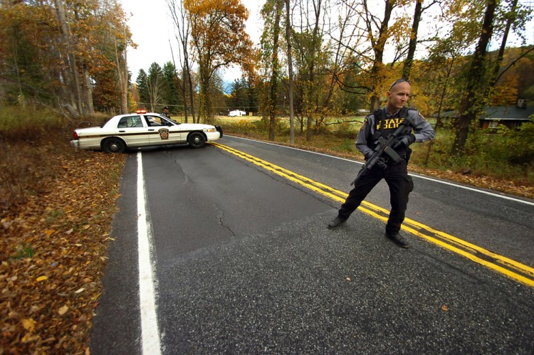 A Pennsylvania State Trooper patrols along a closed section of Lower Swiftwater Road on Saturday, during a massive manhunt for killer Eric Frein in Swiftwater, Pa.