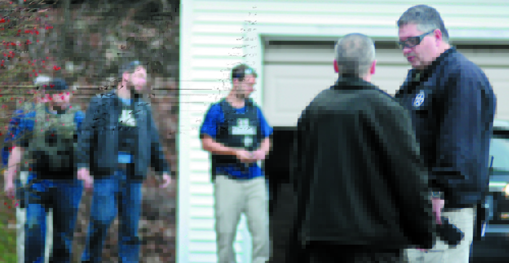 U.S. Marshals Service investigators search the Hallowell home of Barbara Cameron, ex-wife of James Cameron, in November 2012. Authorities spent more than two weeks looking for Cameron in 2012 after he cut off his electronic monitoring bracelet and drove to New Mexico before being captured. Maine’s former top drug prosecutor fled the state after learning his appeal of child pornography convictions had failed.