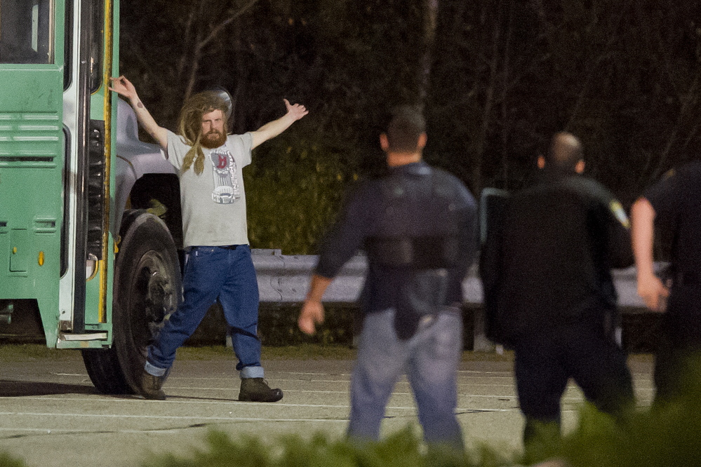 A man surrenders to police Monday night after a three-hour standoff outside the South Portland Target store. The man was on the bus until negotiators were able to convince him to come out.