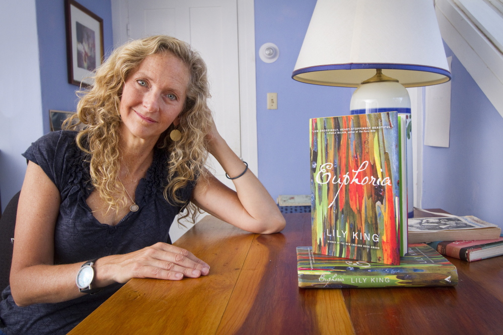 Author Lily King, at her desk in Yarmouth alongside her best-selling novel “Euphoria,” says she found an agreeable rhythm to the seasons in Maine, allowing a comfortable and productive routine to pursue her creativity.