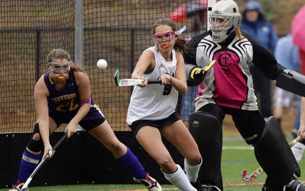 Gorham’s Mary Adams tries to get a stick on the ball in front of the Cheverus goal Tuesday as Cheverus’ Kelsey Masselli backs up goalie Casey Simpson.