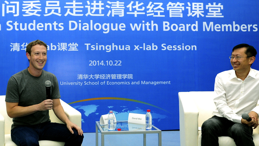 Facebook co-founder Mark Zuckerberg chats with students as a newly appointed member to the advisory board for Tsinghua University School of Economics and Management.