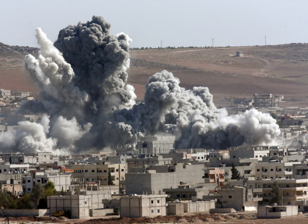Thick smoke from an airstrike by the U.S.-led coalition rises in Kobani, Syria, on Wednesday. The Associated Press